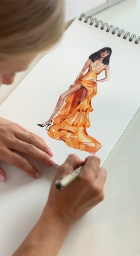 Amber Flame, an orange evening gown being painted in watercolor